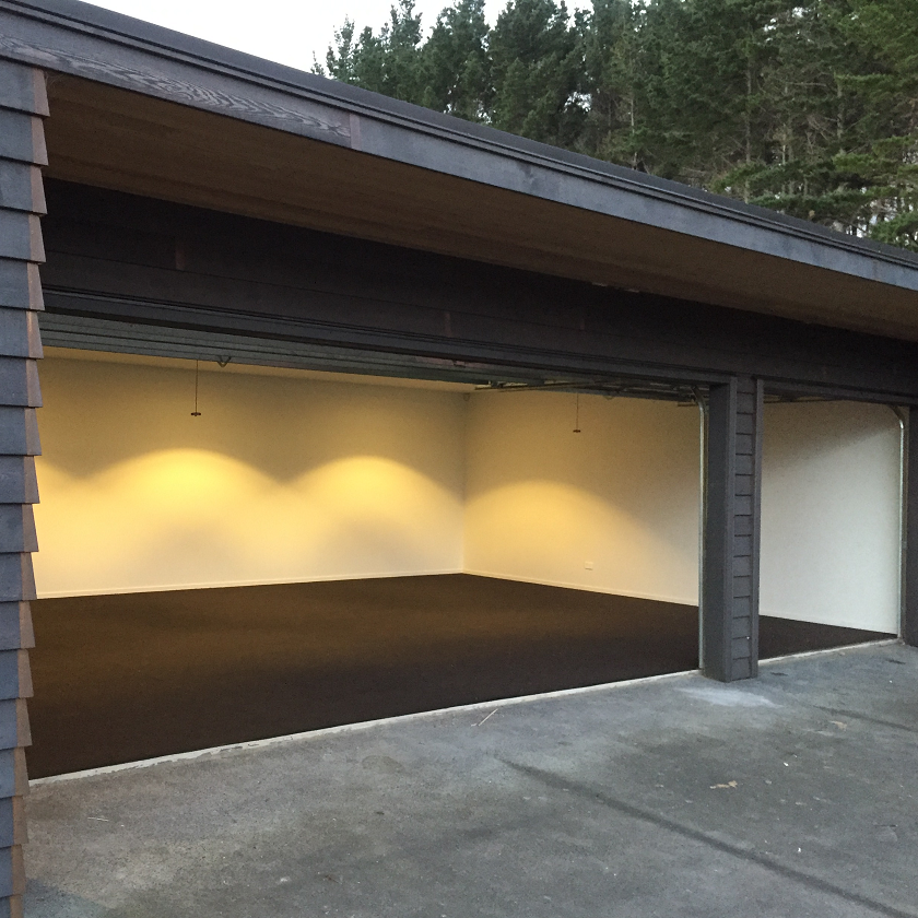 Triple garage with brown garage carpet newly installed