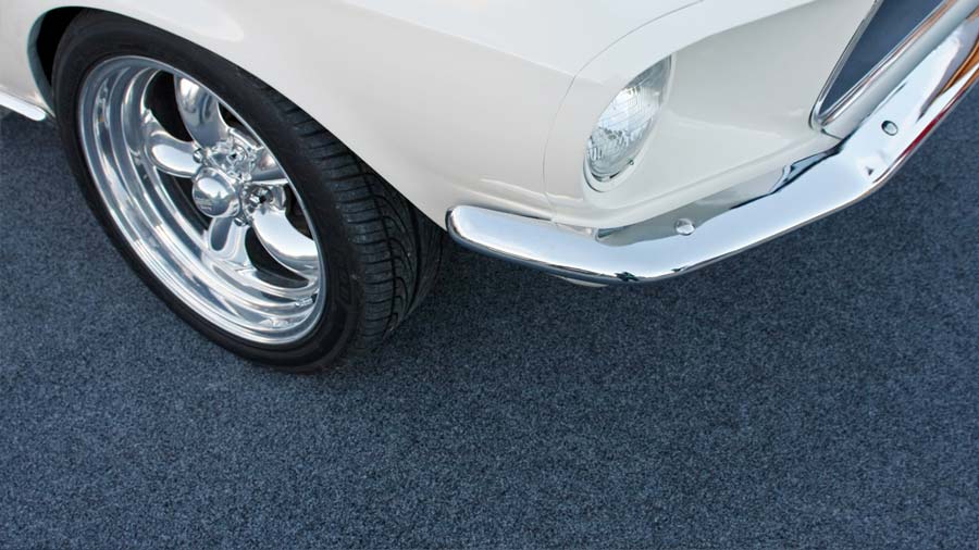 chrome car wheel on garage carpet