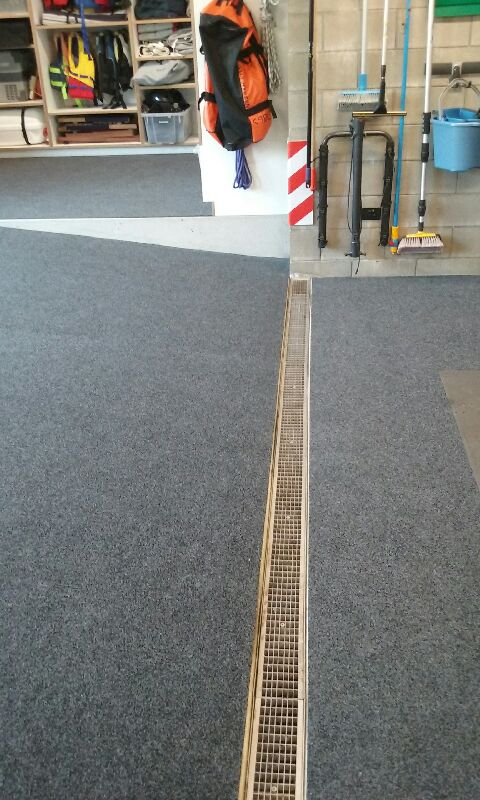 Sloping garage floor with garage carpet