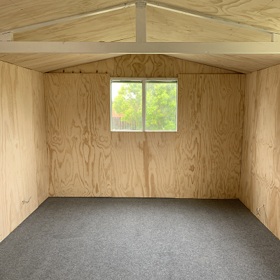 plywood walls with grey carpet