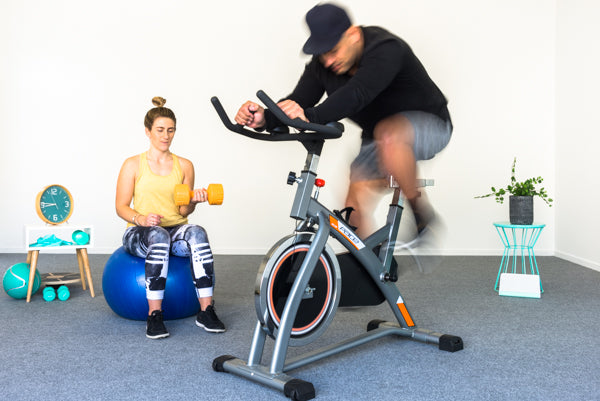 two people working out on garage carpet