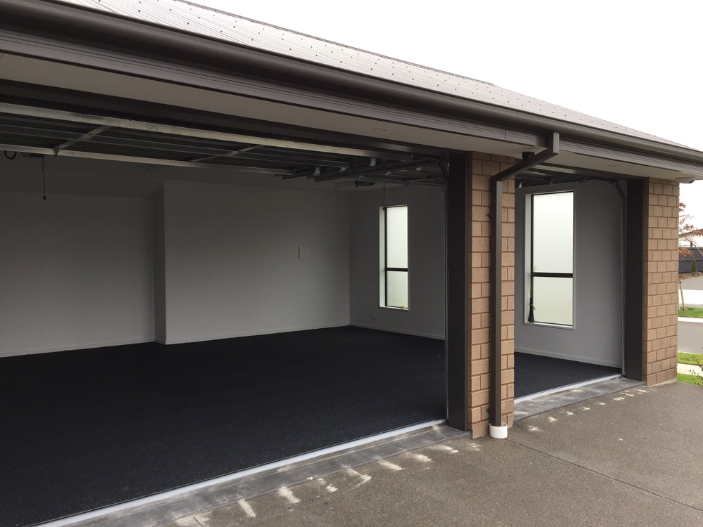 triple garage carpeted in charcoal 