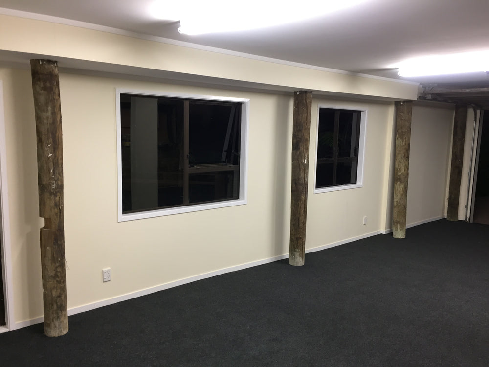 charcoal garage carpet neatly cut around round poles holding up house