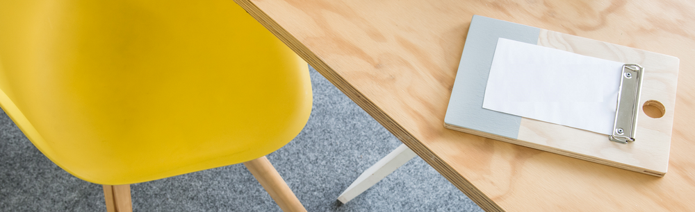 desk with yellow chair on garage carpet