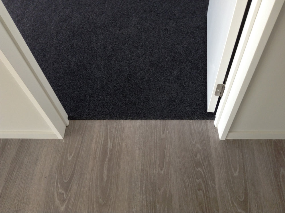 internal garage door with garage carpet butting up to timber floor
